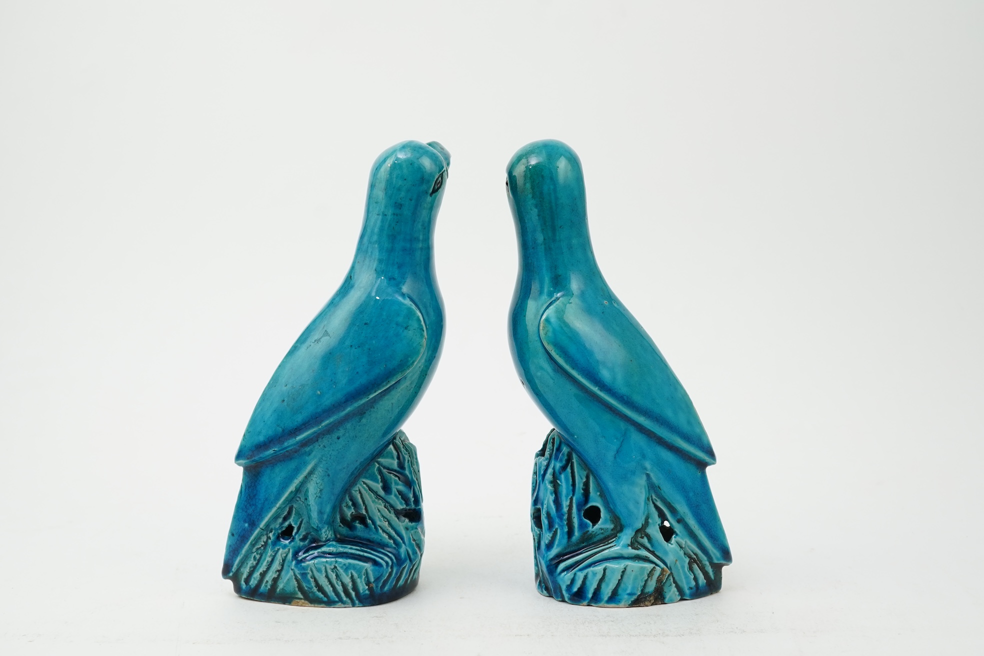 A pair of Chinese turquoise glazed models of parrots, 18th century